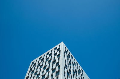 Low angle view of buildings against clear blue sky