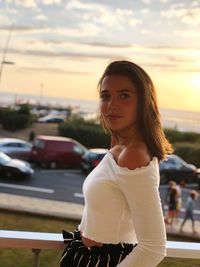 Portrait of woman standing against sky during sunset