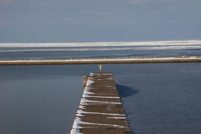 Pier over sea against sky