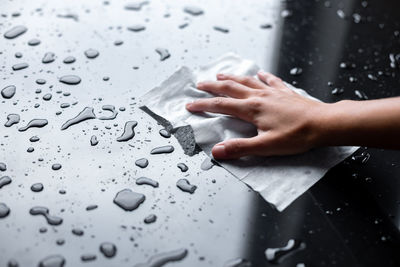 Close-up of water drops on hand