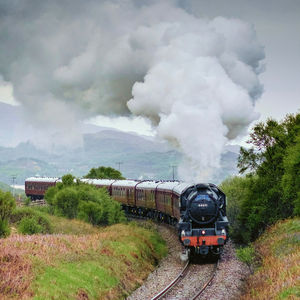 Train on railroad track against sky