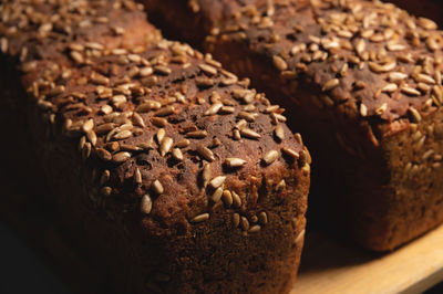 Close-up of rye black bread covered with sunflower seeds. fresh hot bread. healthy food. no yeast