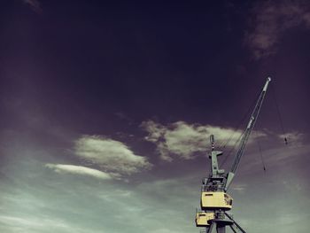 Low angle view of crane against sky