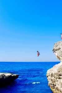 Scenic view of sea against clear blue sky