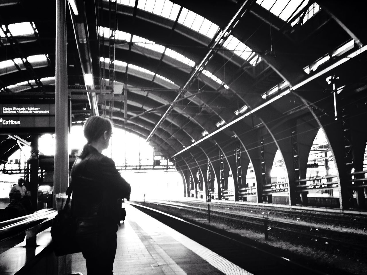 railroad station platform, railroad station, transportation, railroad track, indoors, public transportation, rail transportation, men, lifestyles, rear view, passenger, standing, train - vehicle, walking, architecture, full length, built structure, person