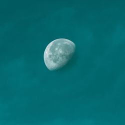 Low angle view of moon against blue sky