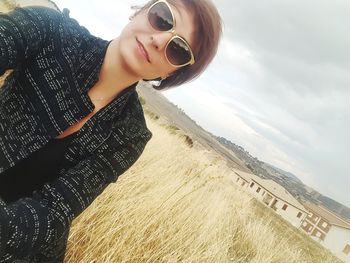 Beautiful young woman against sky