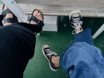Low section of male friends traveling on boat
