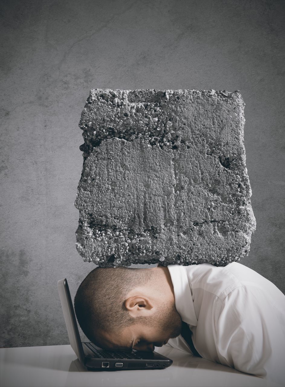 PORTRAIT OF YOUNG MAN AGAINST WALL