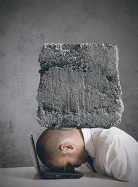 Close-up portrait of young man against wall