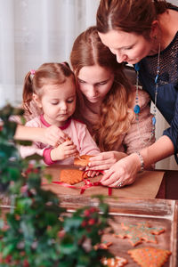 Family preparing gingerbread cookies at home