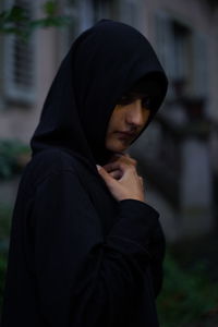 Portrait of beautiful woman standing on cross