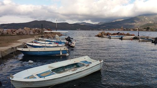 Boats moored on sea against sky