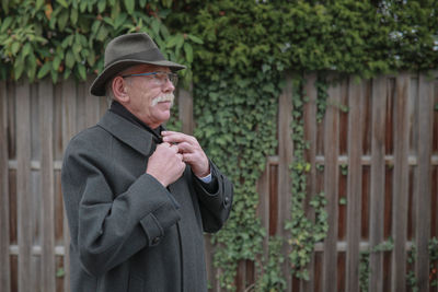 Man looking away while standing outdoors