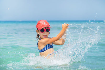 Young woman swimming in sea