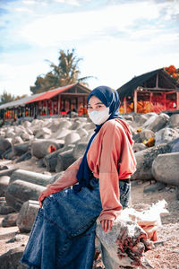 Portrait of woman standing against sky