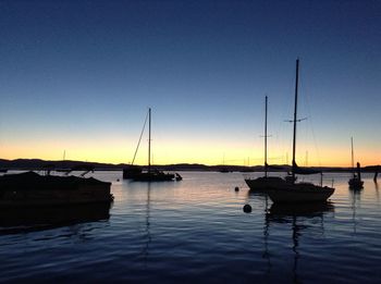 Sailboat in sea at sunset