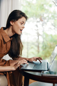 Young woman using laptop at home