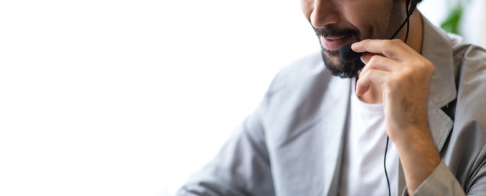 Midsection of man standing against white background