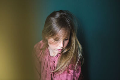 Portrait of girl against wall