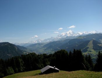 Scenic view of mountains against blue sky