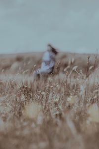 Blurred motion of person on field against sky