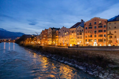 View of colourful buildings across from the river of innsbruck, austria on a late evening