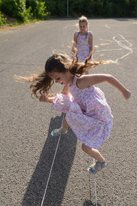 High angle view of girls playing on road