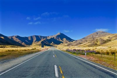 Country road leading towards mountains