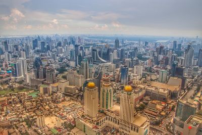 High angle view of modern buildings in city against sky