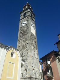 Low angle view of bell tower against blue sky