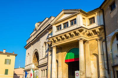 Low angle view of building against clear blue sky