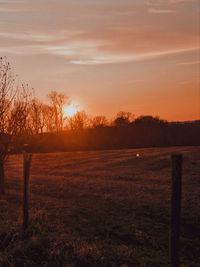 Scenic view of field against sky during sunset