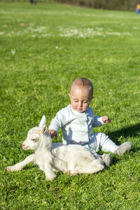 Cute boy with dog on grass