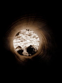 Close-up of hole in water against black background