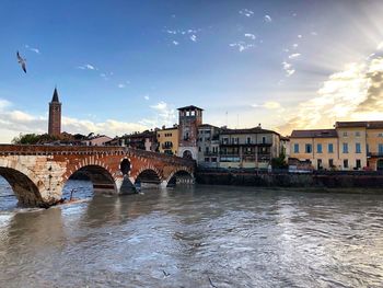 Arch bridge over river in city