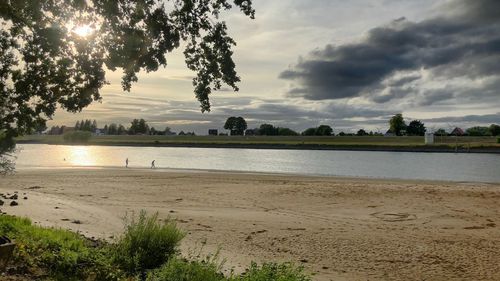 Scenic view of beach against sky during sunset