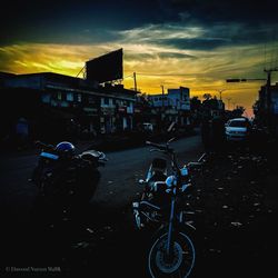 Bicycles parked on road against sky at sunset