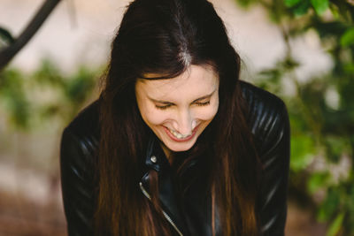 Close-up of smiling woman looking down