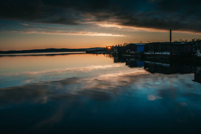 Scenic view of sea against dramatic sky during sunset