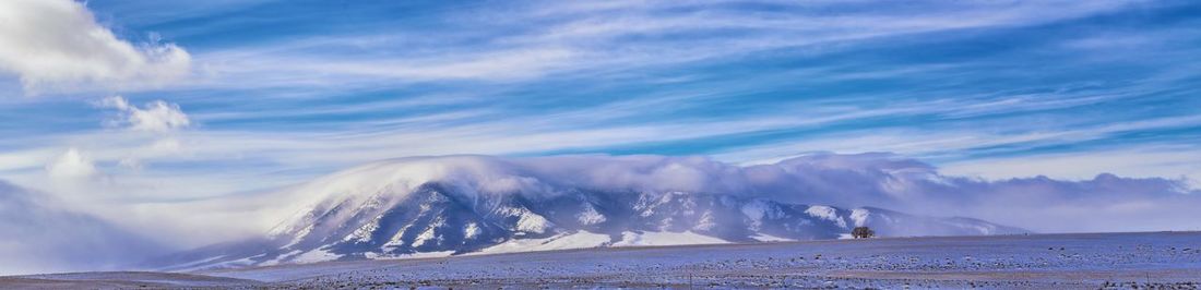 Scenic view of snowcapped mountains against sky