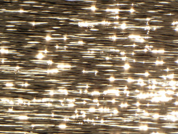 Full frame shot of illuminated light reflection in water