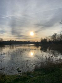 Scenic view of lake against sky during sunset