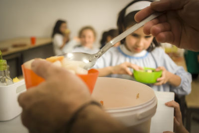 Close-up of girl having food at home