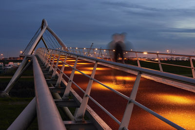 Blurred motion of bridge against sky in blue hour