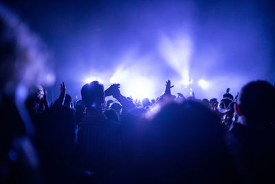 People enjoying music concert at night