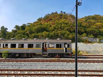 Train by railroad tracks against sky
