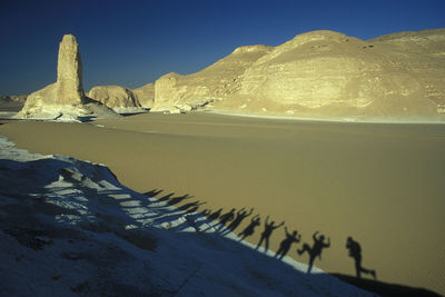 Shadow of people on desert landscape