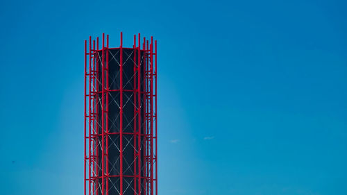 Low angle view of crane against blue sky