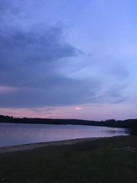 Scenic view of beach against sky at sunset